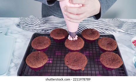 Step By Step. Piping Italian Buttercream Frosting On Top Of Red Velvet Cupcakes.