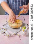 Step by step preparation of Easter cake or other Easter baking on pink concrete background. Adding raisins to the kneaded dough. Happy Easter. Step by step recipes