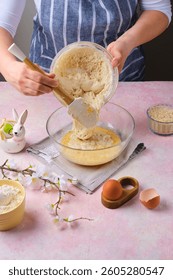 Step by step preparation of Easter cake or other Easter pastries on pink concrete background. Adding fermented poolish to butter and eggs. Happy Easter. Step by step recipes