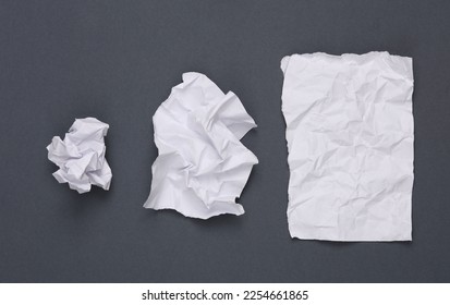 Step by step process of crumpling paper into a ball on gray background - Shutterstock ID 2254661865