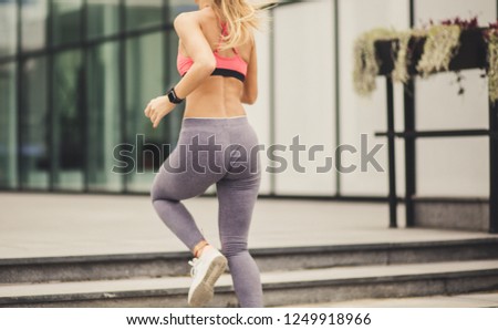 Similar – Frau in Sportbekleidung mit Kopfhörern, die wie ein Smartphone aussehen.