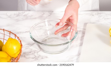 Step By Step. Squeezing Fresh Lemon Juice Into A Small Glass Mixing Bowl.