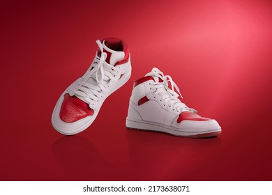 Step By Step. Strolling Sports Shoes On Red Background. Sneakers Or Trainers Isolated. Athletic Shoes. Fitness, Sport, Training Concept. Urban Fashion. Copy Space For Ad, Text, Design