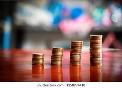step of coins stacks with sandglassor hourglass, saving and investment or family planning concept, motion blured background. - Shutterstock ID 1258974418