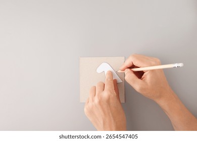 step in creative project, Hand tracing horse head stencil on cardboard, educational DIY craft preparation, ideal for schools, art teachers, kids workshops, creativity businesses, stationery brands, 