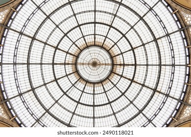 Step into the grandeur of the Galleria Vittorio Emanuele II, Milan's iconic 19th-century shopping arcade, as this captivating photograph showcases its intricate architectural details.  - Powered by Shutterstock