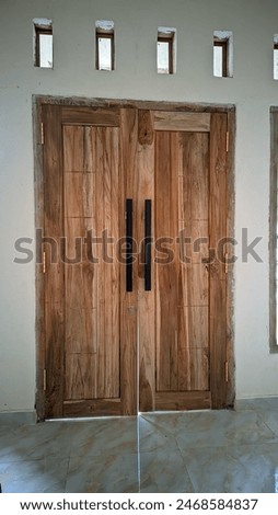 Step into the past with this captivating image of an aged door, weathered by time yet retaining its timeless charm. Imbued with nostalgia, it stands as a testament to enduring timeless beauty. 