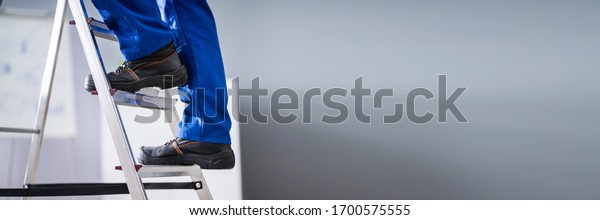 Step Ladder Safety.\
Worker Man In Shoes
