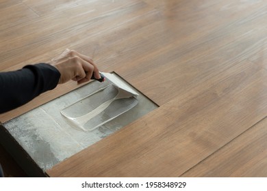 Step of vinyl flooring installation : type of glue stick vinyl sheet on decoration site to installing vinyl floor materiel - Shutterstock ID 1958348929