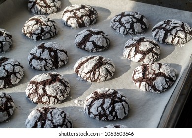 Step-by-Step. Baking Homemade Chocolate Crinkle Cookies With Powdered Sugar Icing. Hot Fresh Cookies On Parchment Paper.