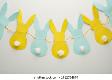 Step-by-step creation of a garland of bunnies. DIY concept. DIY decoration for the Easter holiday.