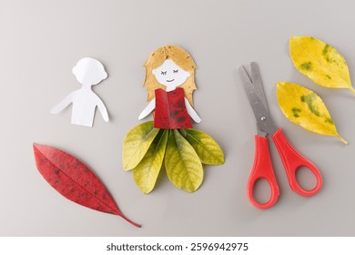 Step-by-step creation of paper and leaf doll showing handmade craft process. Dried leaves DIY nature art. Great for children crafts, art blogs, seasonal activity