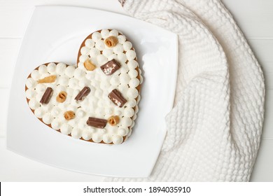 Step-by-step heart-shaped cake recipe instructions. Step 12: Decorate the cake with chocolate chips, waffles, cookies. Flat lay. - Powered by Shutterstock