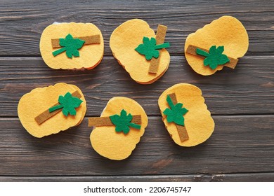 Step-by-step instructions for decorative crafts pumpkin made of felt for Halloween. Carved details of several pumpkins - Shutterstock ID 2206745747