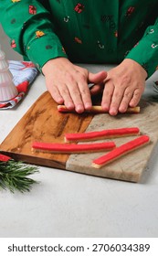 Step-by-step preparation of Candy Cane shortbread cookies in Christmas decor on a light concrete background. Merry Christmas! Traditional Christmas treats
