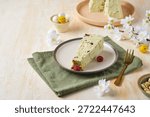 Step-by-step preparation of a cottage cheese Easter dessert in the shape of a truncated cone with pistachio paste, white chocolate and dried cranberries. The finished sliced ​​dessert is on a plate. Happy Easter.(