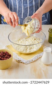 Step-by-step preparation of a cottage cheese Easter dessert in the shape of a truncated cone with pistachio paste, white chocolate and dried cranberries. Add butter. Happy Easter.