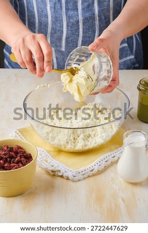 Step-by-step preparation of a cottage cheese Easter dessert in the shape of a truncated cone with pistachio paste, white chocolate and dried cranberries. Add butter. Happy Easter.
