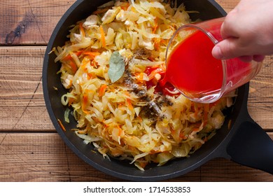 Step-by-step preparation of stewed cabbage with chicken breast fillet, step 4 - adding spices, bay leaf and tomato paste, selective focus