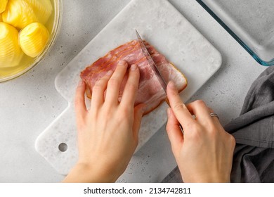 Step-by-step Recipe Of Potato Casserole With Bacon. Woman Hands Cut Becon, Ham On Marble Board. Top View