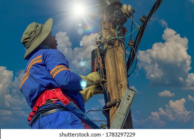 Stepladder Holding An African American Electrician On A Pole, Repairing A Transformer