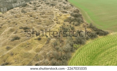 Steppe pits drone aerial limestone mine Kosirske lomy national nature reserve. Valuable botanical grass meadow thermophilic landscape greater pasque flower Pulsatilla grandis hole stone rock Europe