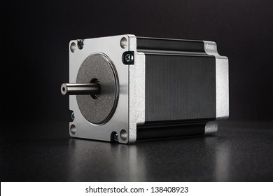 Stepper Motor With NEMA Standard Flange, Used For Driving Linear Axes Of CNC Machines Like 3D Printers And Routers, On Dark Background With Diffused Reflection