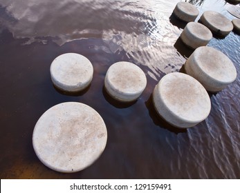 Stepping Stones In Water Of A Pond