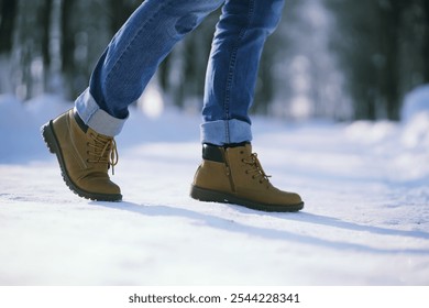 Steps along the snow-covered path. A man walks in the park in the winter.
 - Powered by Shutterstock