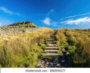 Steps climbing up towards the mountain of Pen-y-ghent in the Yorkshire Dales National Park. The mountain is 2,277 feet high.
