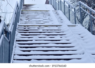 The Steps And Handrails Of The Railway Bridge Are Covered With Thick White Snow.High Quality Photo