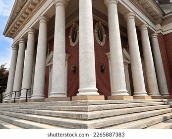 Steps leading up to brick church with white pillars. - Shutterstock ID 2265887383