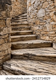 Steps wind up the outside of a stone tower near the town of Porto Vecchio on Corsica.