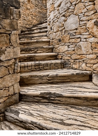 Steps wind up the outside of a stone tower near the town of Porto Vecchio on Corsica.