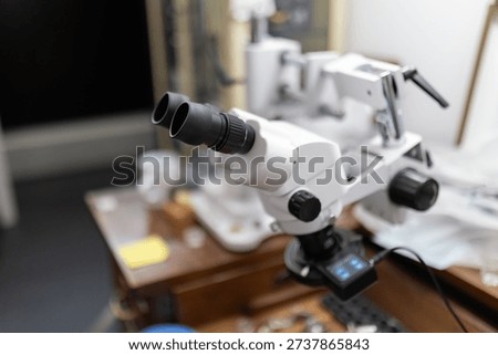 Stereo microscope on workbench magnifying details for precision work