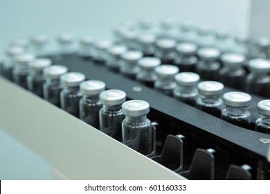 Sterile bottles and ampoules on the dispensing line.Sealed ampoules with medicine.Sterile capsules for injection. Bottles on the bottling line of the pharmaceutical plant.
