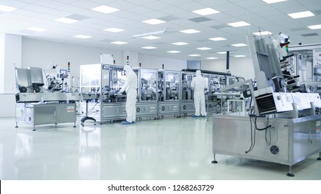 Sterile High Precision Manufacturing Laboratory where Scientists in Protective Coverall's Turn on Machninery, Use Computers and Microscopes, doing Pharmaceutics, Biotechnology Research.