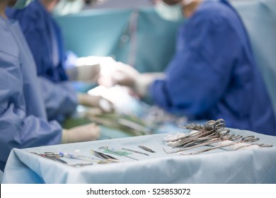 sterile surgical instruments on during the operation table amid the surgeons - Powered by Shutterstock