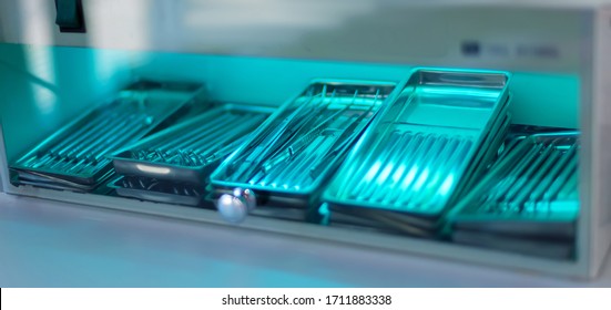 Sterilization Of Dentall Instrument With Ultraviolet Lamp In Dental Clinic. Closeup Different Medical  Instruments And Accessories Inside Ultraviolt Steriliser. Medical Instruments Sterilized Under UV