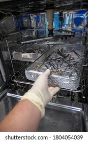 In A Sterilization Department Of A Hospital, Surgical Instruments Are Pushed Into An Instrument Washing Machine