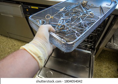 In A Sterilization Department Of A Hospital, Surgical Instruments Are Pushed Into An Instrument Washing Machine