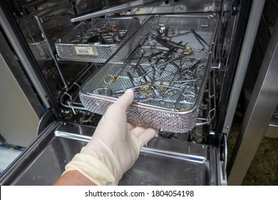 In A Sterilization Department Of A Hospital, Surgical Instruments Are Pushed Into An Instrument Washing Machine