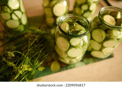 Sterilized Glass Canning Cans With Preserved Slices Of Ripe Organic Vegetable Marrow, Marinated In Salt Vinegar Brine And Fresh Dill On The Kitchen Table. Food Preservation. Preserving For The Winter