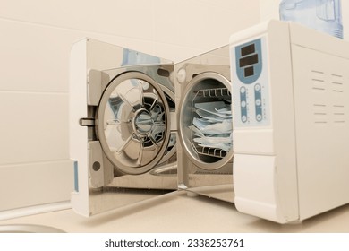 Sterilizing medical instruments in autoclave. Dental office. Selective focus. Sterile dental tools - Shutterstock ID 2338253761