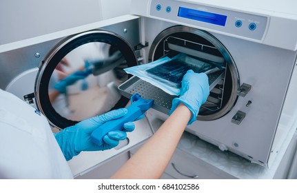 Sterilizing medical instruments in autoclave. Dental office - Shutterstock ID 684102586