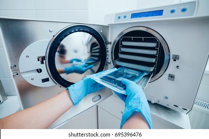 Sterilizing Medical Instruments In Autoclave. Dental Office