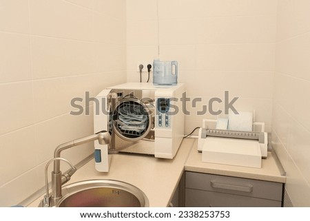 Sterilizing medical instruments in autoclave. Dental office. Selective focus. Sterile dental tools