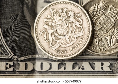 Sterling pound coin on an American one dollar bill.