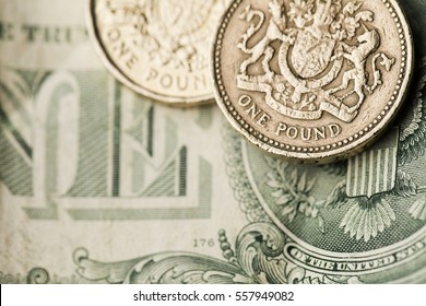 Sterling pound coin on an American one dollar bill.