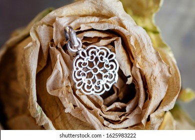 Sterling Silver Pendant In Shape Of Mandala Placed On Dried Rose